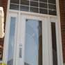 exterior view of white single door with sidelites and shaped transom featuring decorative glass and grills