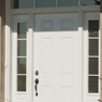 exterior view of single white entrance door featuring sidelites and transom