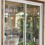interior view of two panel white vinyl patio door with brown wood trim