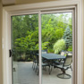interior view of two panel beige vinyl patio door surrounded by white wood trim