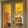 exterior patio view of wood finish stained vinyl two panel terrace door with matching side windows