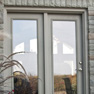 exterior deck view of sage stained vinyl terrace door with matching fixed door