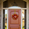 exterior view of an orange single entrance door with sidelites and transon