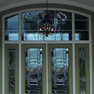 exterior view of a green double entrance door with sidelites and shaped transom featuring full panel decorative glass