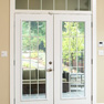 interior view of beige vinyl terrace doors with matching windows and transoms featuring grills