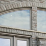 exterior patio view of set of three shaped sage stained fixed windows