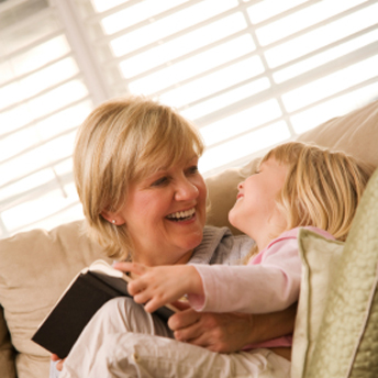 Mother and child cuddling in the warmth of a sofa